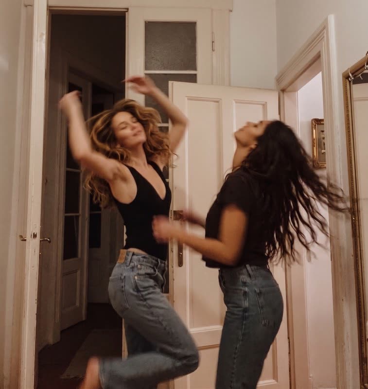 Two friends dancing and laughing together